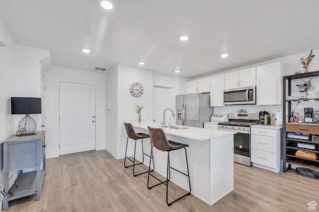 388 N Regatta Ln, Saratoga Springs, UT 84045 - kitchen with appliances with stainless steel finishes, light wood-type flooring, a kitchen breakfast bar, and a sink