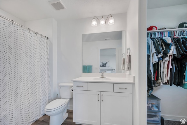 388 N Regatta Ln, Saratoga Springs, UT 84045 - bathroom featuring vanity, wood finished floors, visible vents, baseboards, and toilet