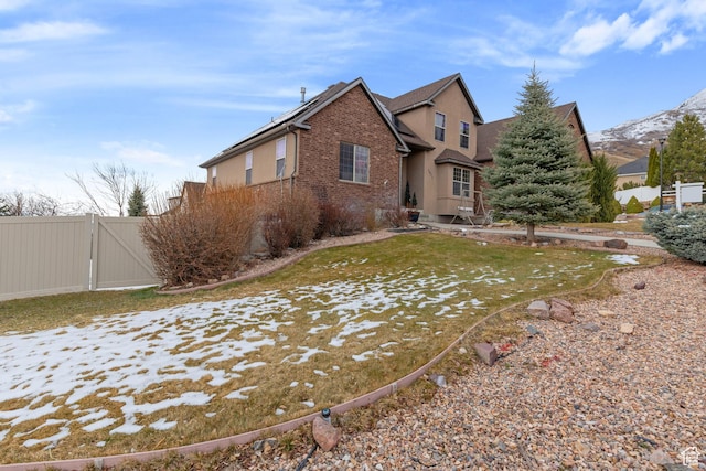 1035 E 300 S, Santaquin, UT 84655 - view of home's exterior with a gate, fence, brick siding, and a mountain view