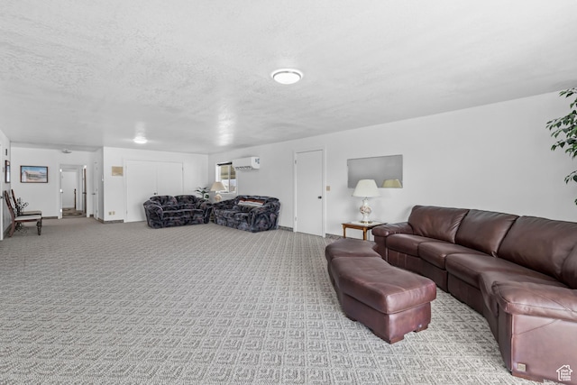 carpeted living room with a wall mounted air conditioner and a textured ceiling