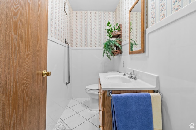 bathroom featuring tile patterned flooring, visible vents, toilet, and vanity