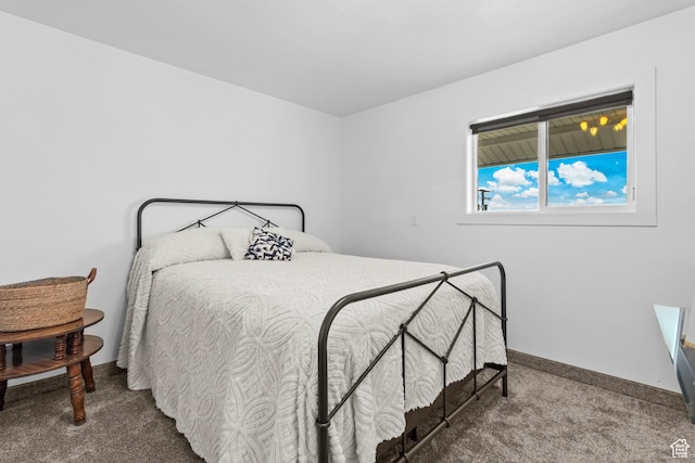 carpeted bedroom with baseboards