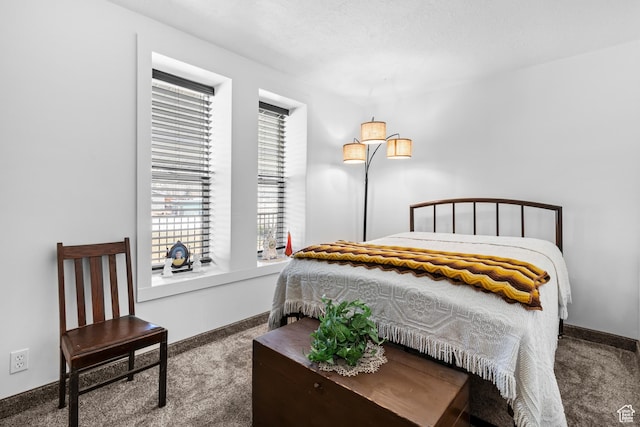 carpeted bedroom featuring baseboards