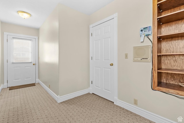 hall with light colored carpet and baseboards