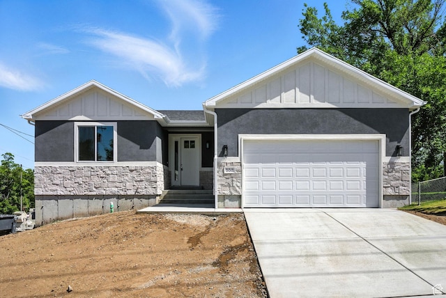 552 E 41st St, South Ogden, UT 84403 - view of front facade featuring stone siding, board and batten siding, driveway, a garage, and stucco siding