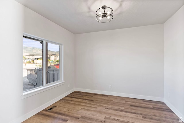 552 41st St, South Ogden, UT 84403 - empty room featuring baseboards, visible vents, wood finished floors, and an inviting chandelier