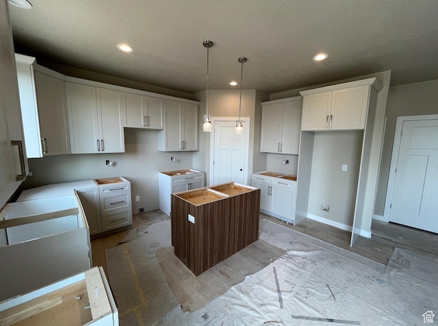 552 41st St, South Ogden, UT 84403 - kitchen with a center island, light wood-style flooring, a textured ceiling, white cabinetry, and recessed lighting