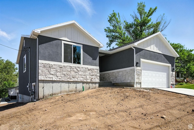 552 E 41st St, South Ogden, UT 84403 - ranch-style home featuring stone siding, an attached garage, concrete driveway, board and batten siding, and stucco siding