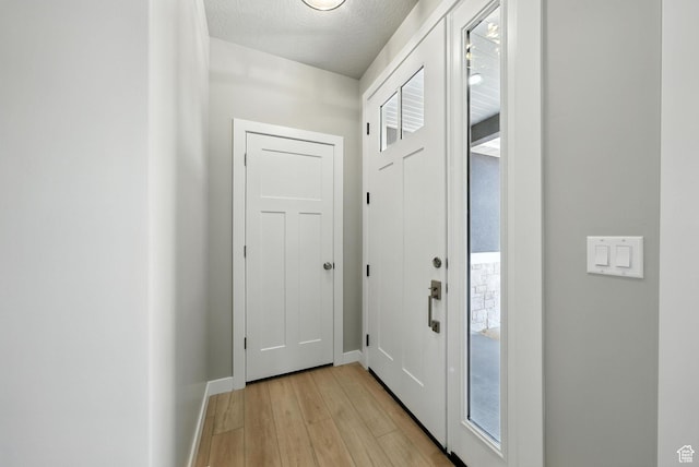 552 E 41st St, South Ogden, UT 84403 - doorway to outside featuring light wood-style flooring and a textured ceiling