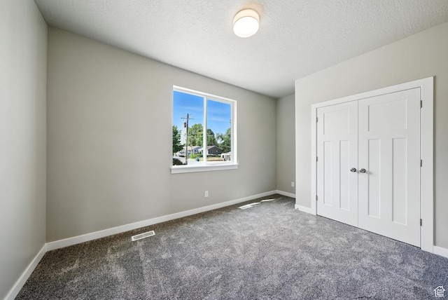 552 E 41st St, South Ogden, UT 84403 - unfurnished bedroom featuring carpet floors, a closet, and a textured ceiling