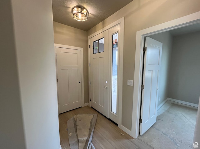 552 41st St, South Ogden, UT 84403 - entrance foyer with baseboards, a textured ceiling, and light wood finished floors