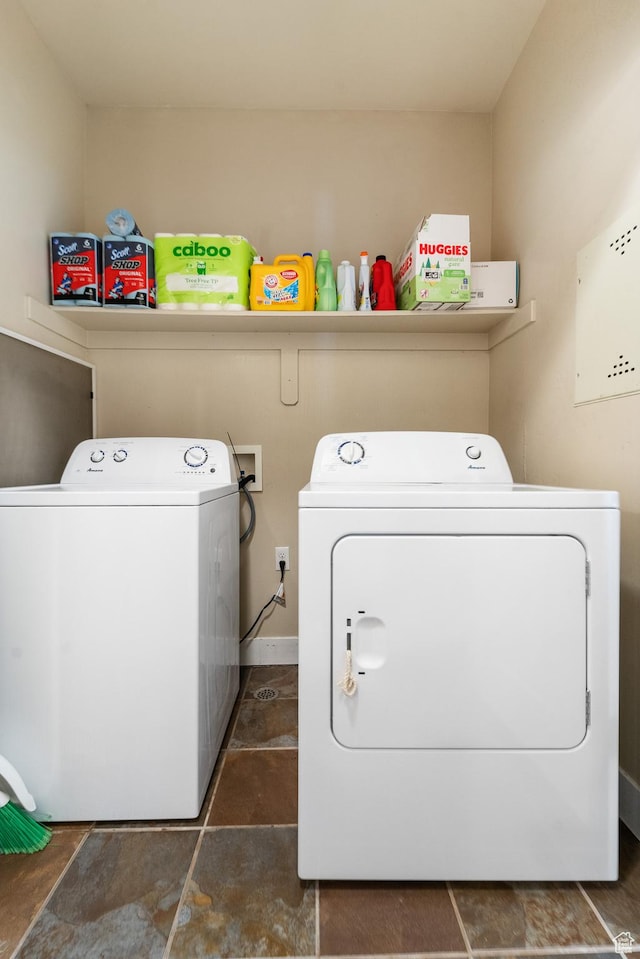 clothes washing area featuring laundry area and washing machine and clothes dryer