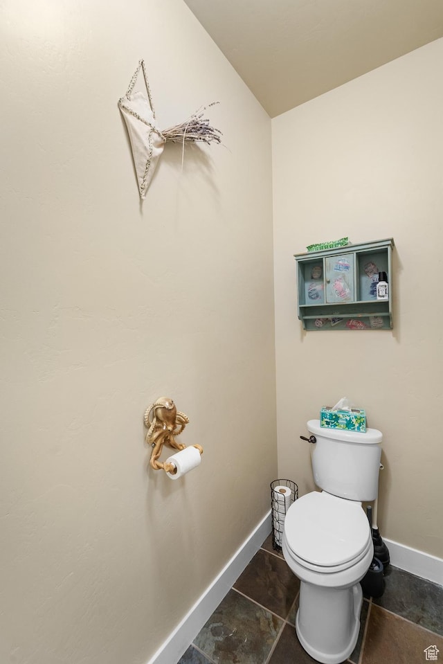 bathroom featuring toilet and baseboards