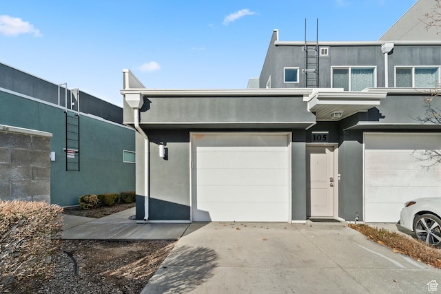 multi unit property featuring driveway and stucco siding