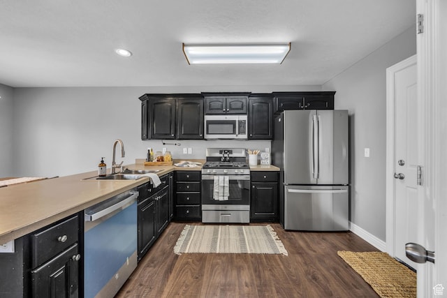 162 S 500 W, Tremonton, UT 84337 - kitchen featuring a sink, dark cabinetry, dark wood finished floors, appliances with stainless steel finishes, and light countertops