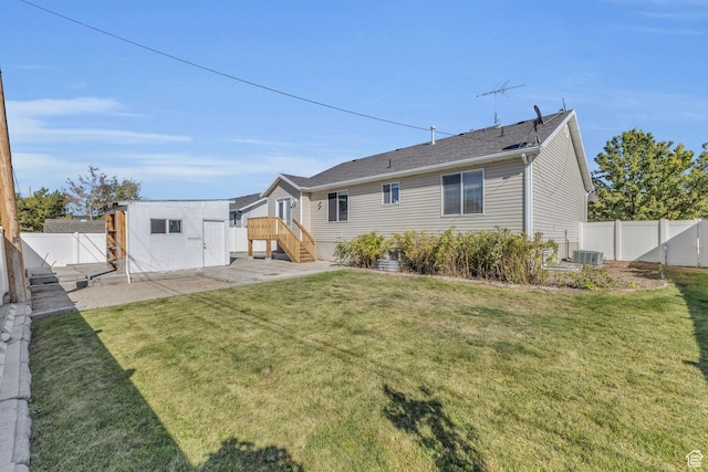162 S 500 W, Tremonton, UT 84337 - back of property featuring central AC unit, an outbuilding, a yard, and a fenced backyard
