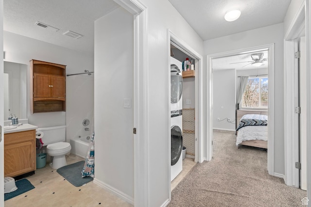 137 W 600 N Unit 205, Tooele, UT 84074 - full bath featuring visible vents, a textured ceiling, vanity, and stacked washer / drying machine