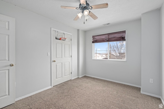 137 W 600 N Unit 205, Tooele, UT 84074 - unfurnished bedroom with visible vents, a ceiling fan, a textured ceiling, carpet floors, and baseboards