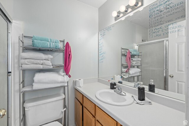 137 W 600 N Unit 205, Tooele, UT 84074 - bathroom featuring a shower with shower door, toilet, and vanity