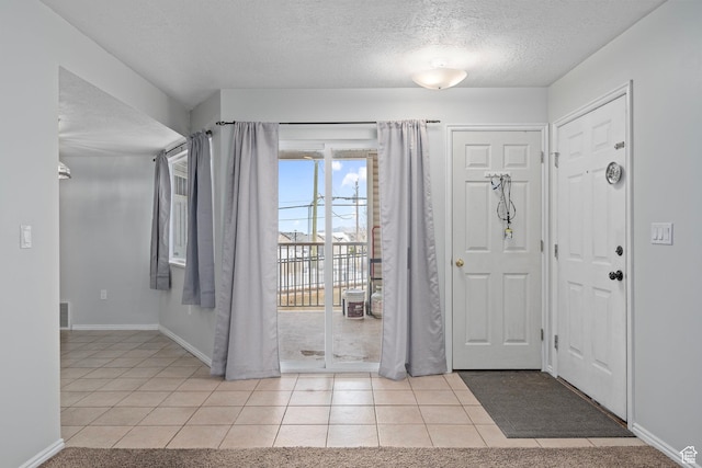 137 W 600 N Unit 205, Tooele, UT 84074 - entrance foyer featuring light tile patterned floors, visible vents, a textured ceiling, and baseboards