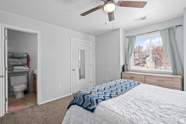 137 W 600 N Unit 205, Tooele, UT 84074 - bedroom with visible vents, baseboards, carpet, ensuite bathroom, and a textured ceiling