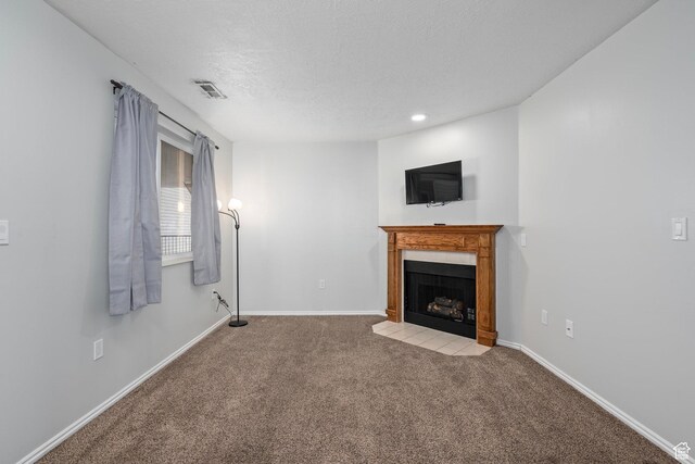 137 W 600 N Unit 205, Tooele, UT 84074 - unfurnished living room with baseboards, a fireplace, visible vents, and light carpet