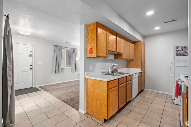 137 W 600 N Unit 205, Tooele, UT 84074 - kitchen featuring visible vents, light countertops, light tile patterned floors, white appliances, and a sink