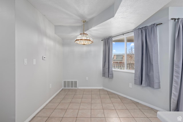 137 W 600 N Unit 205, Tooele, UT 84074 - unfurnished room with baseboards, visible vents, light tile patterned flooring, a textured ceiling, and a chandelier