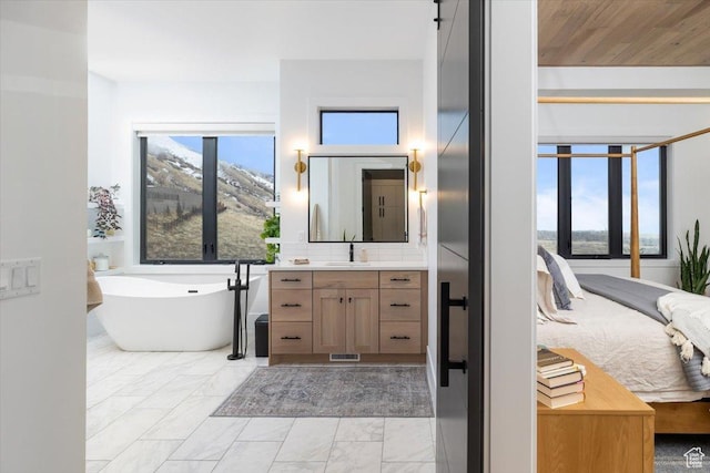 2940 Naomi Dr, North Logan, UT 84341 - full bath with a soaking tub, vanity, marble finish flooring, and ensuite bath