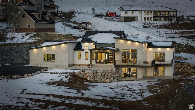 2940 Naomi Dr, North Logan, UT 84341 - snow covered rear of property with a balcony and stone siding