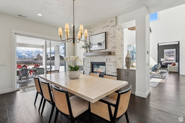 165 E Wasatch Way, Snyderville, UT 84098 - dining room featuring dark wood finished floors, a notable chandelier, a brick fireplace, and visible vents