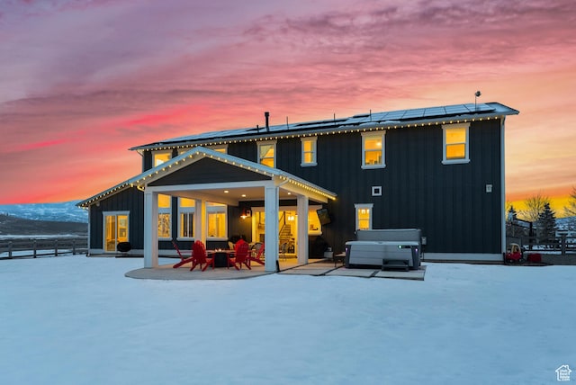 165 E Wasatch Way, Snyderville, UT 84098 - back of property with a patio, roof mounted solar panels, fence, board and batten siding, and a hot tub