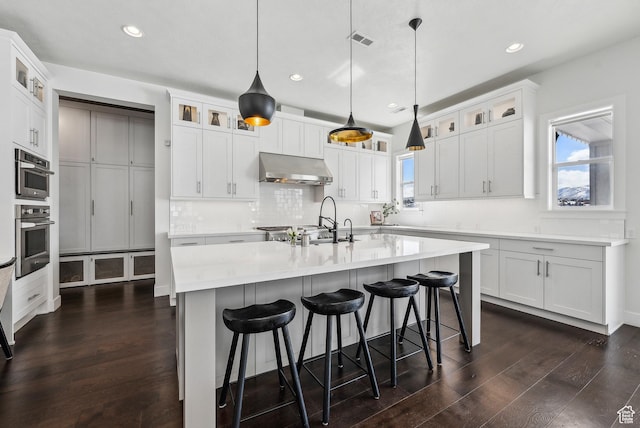 165 E Wasatch Way, Snyderville, UT 84098 - kitchen featuring dark wood-type flooring, backsplash, visible vents, and under cabinet range hood