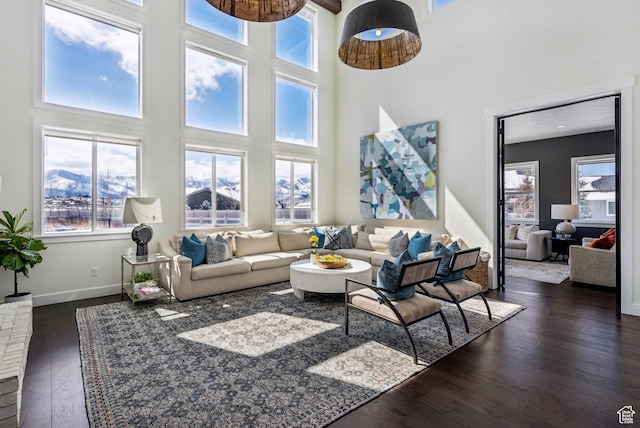 165 E Wasatch Way, Snyderville, UT 84098 - living area with baseboards, dark wood finished floors, and a towering ceiling