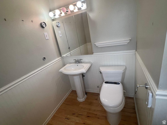916 E Sunburn Ln, Sandy, UT 84094 - bathroom with hardwood / wood-style flooring, toilet, and wainscoting