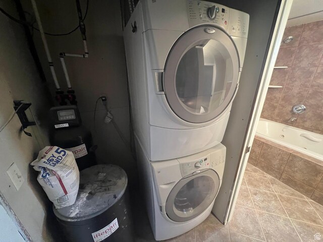 916 E Sunburn Ln, Sandy, UT 84094 - clothes washing area with stacked washer / drying machine, light tile patterned flooring, and laundry area
