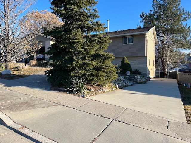 916 E Sunburn Ln, Sandy, UT 84094 - view of property exterior featuring brick siding and concrete driveway
