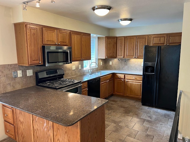 916 E Sunburn Ln, Sandy, UT 84094 - kitchen featuring brown cabinets, a peninsula, black appliances, and a sink