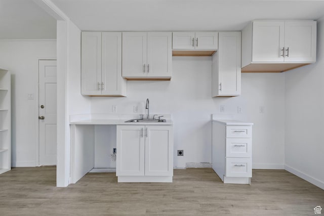 154 S 400 E, American Fork, UT 84003 - kitchen with a sink, white cabinets, light countertops, and light wood finished floors