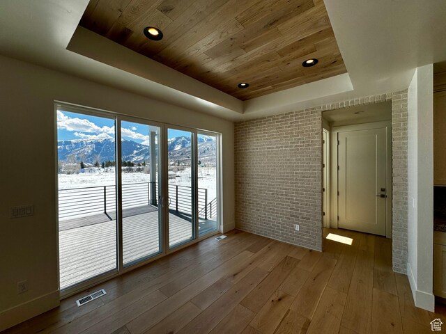 3151 E 5225 N Unit 11, Liberty, UT 84310 - unfurnished room featuring brick wall, visible vents, a tray ceiling, and wood ceiling