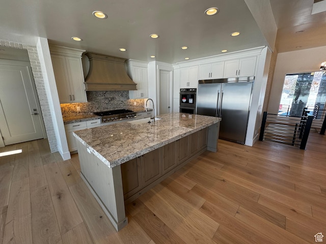 3151 E 5225 N Unit 11, Liberty, UT 84310 - kitchen with custom exhaust hood, a sink, cooktop, built in fridge, and light wood finished floors