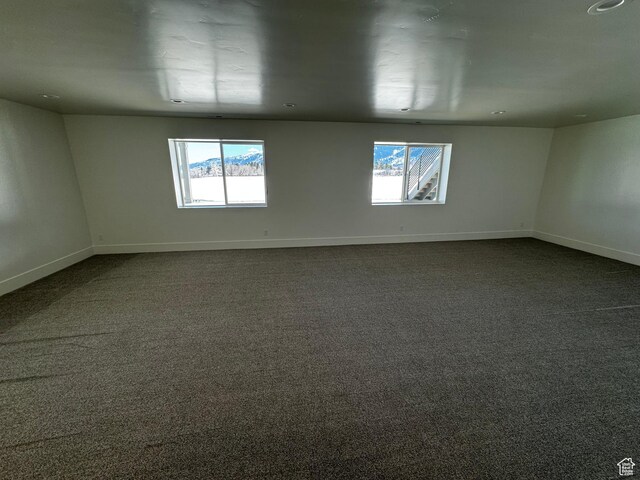 3151 E 5225 N Unit 11, Liberty, UT 84310 - empty room with dark colored carpet, plenty of natural light, and baseboards