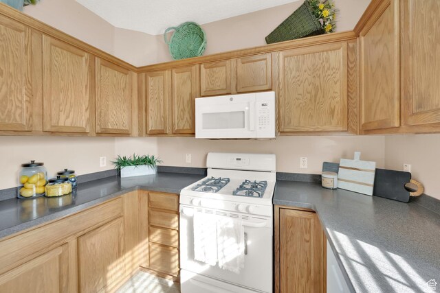 8851 S Humboldt Ct W, West Jordan, UT 84081 - kitchen featuring white appliances, dark countertops, and light brown cabinets