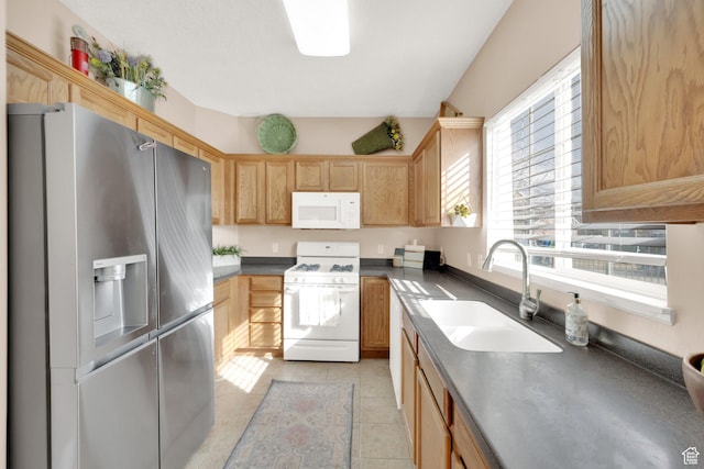 8851 S Humboldt Ct W, West Jordan, UT 84081 - kitchen featuring white appliances, healthy amount of natural light, dark countertops, and light tile patterned floors