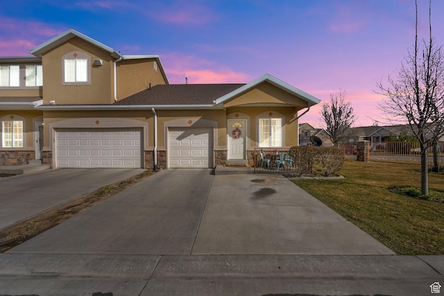8851 S Humboldt Ct W, West Jordan, UT 84081 - view of front of house featuring stucco siding, driveway, stone siding, and a garage