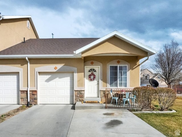 8851 S Humboldt Ct W, West Jordan, UT 84081 - view of front of home with driveway, stucco siding, an attached garage, and a porch