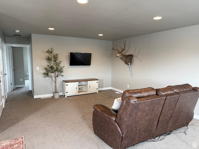 living area featuring carpet flooring, recessed lighting, baseboards, and a textured ceiling