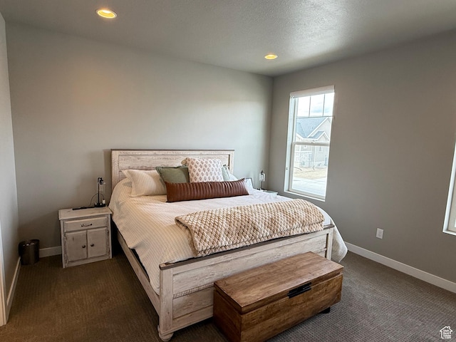 bedroom featuring recessed lighting, a textured ceiling, baseboards, and dark colored carpet