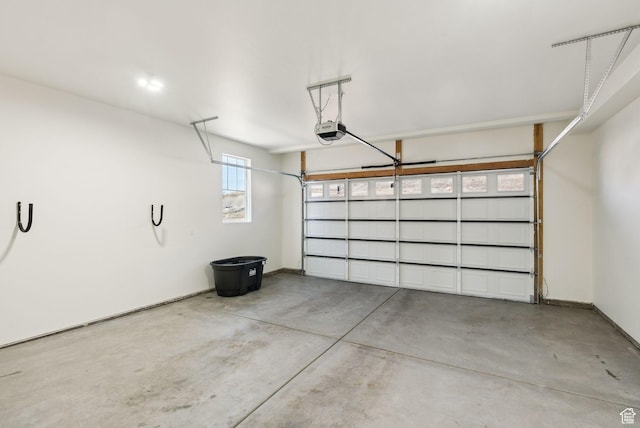 6005 N Westridge Rd, Heber City, UT 84032 - garage featuring baseboards and a garage door opener
