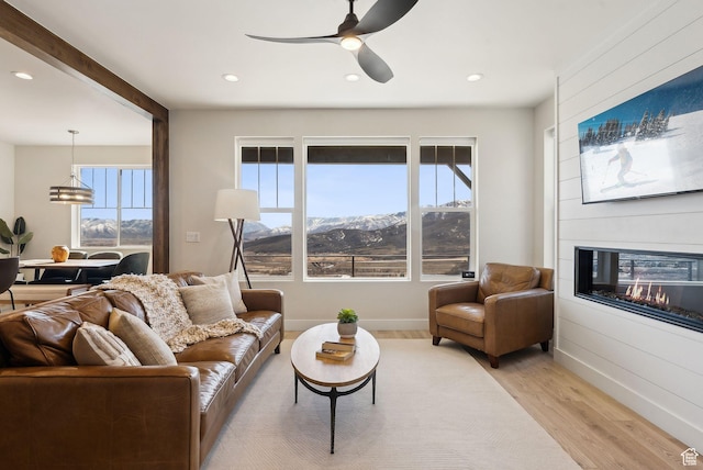6005 N Westridge Rd, Heber City, UT 84032 - living area featuring a ceiling fan, a large fireplace, recessed lighting, and light wood-type flooring